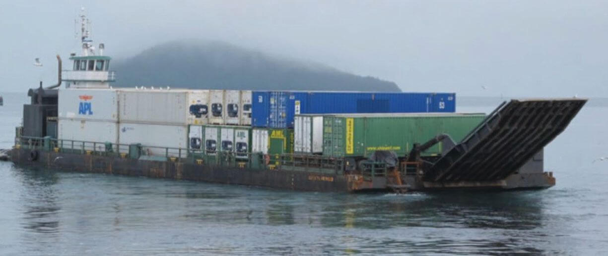 The integrated tug and barge Krystal Sea and Cordova Provider loaded with shipping containers, with the barge's bow ramp raised, in 2013.
